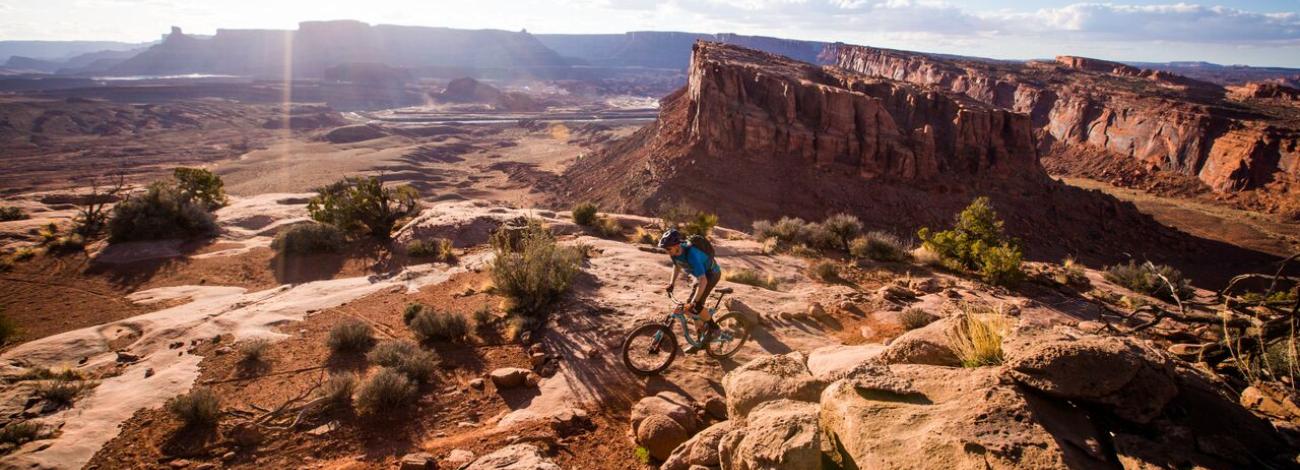 Mountain biker riding slickrock above the Moab desert